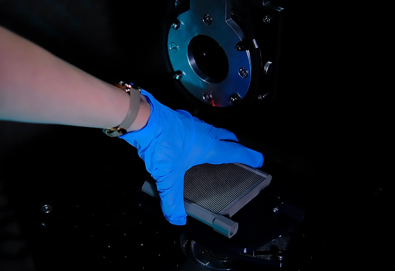 An additive manufactured metal part being prepared for a nonlinear resonance NDT test